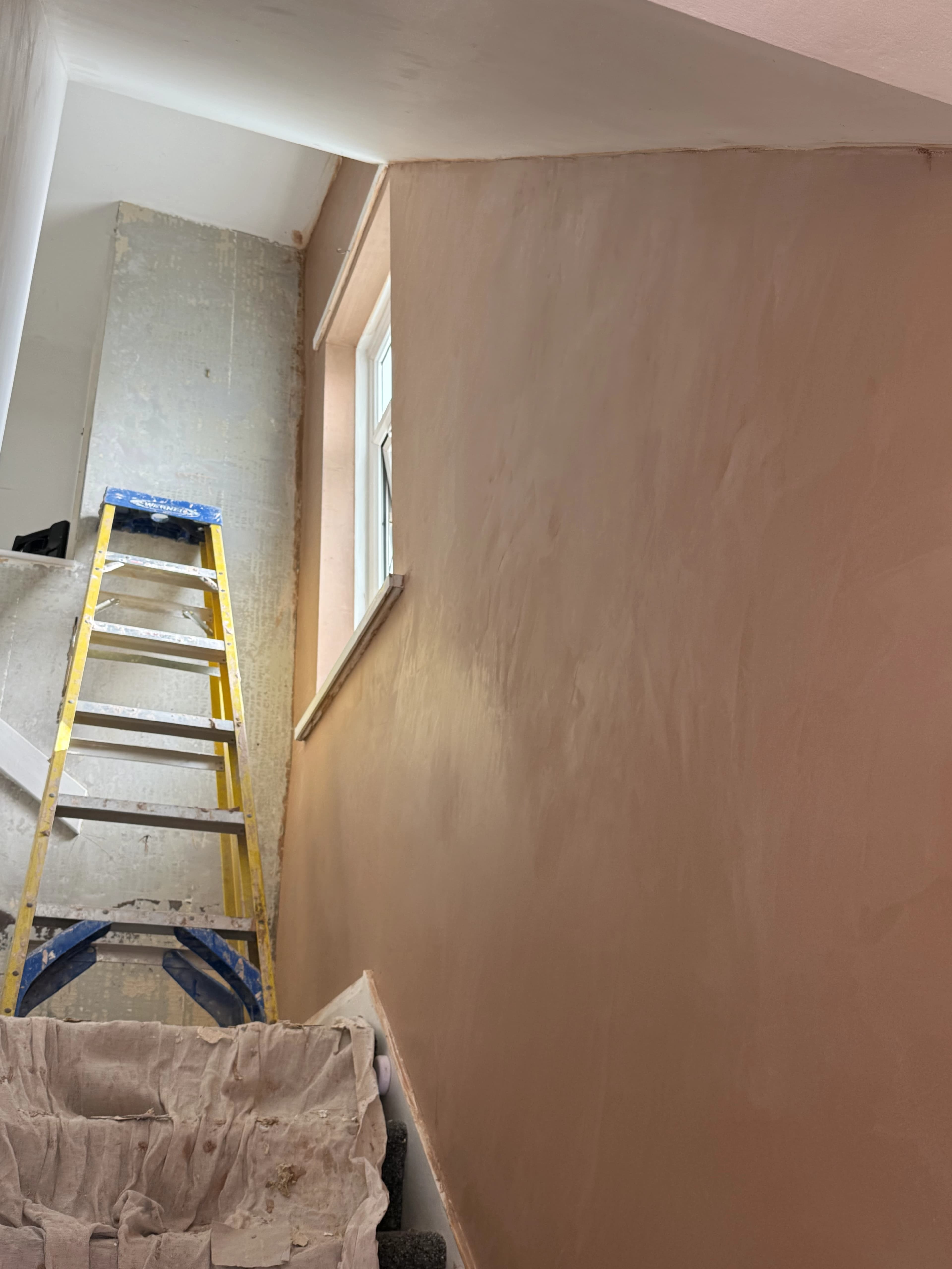 Professional plasterer applying a smooth skim coat